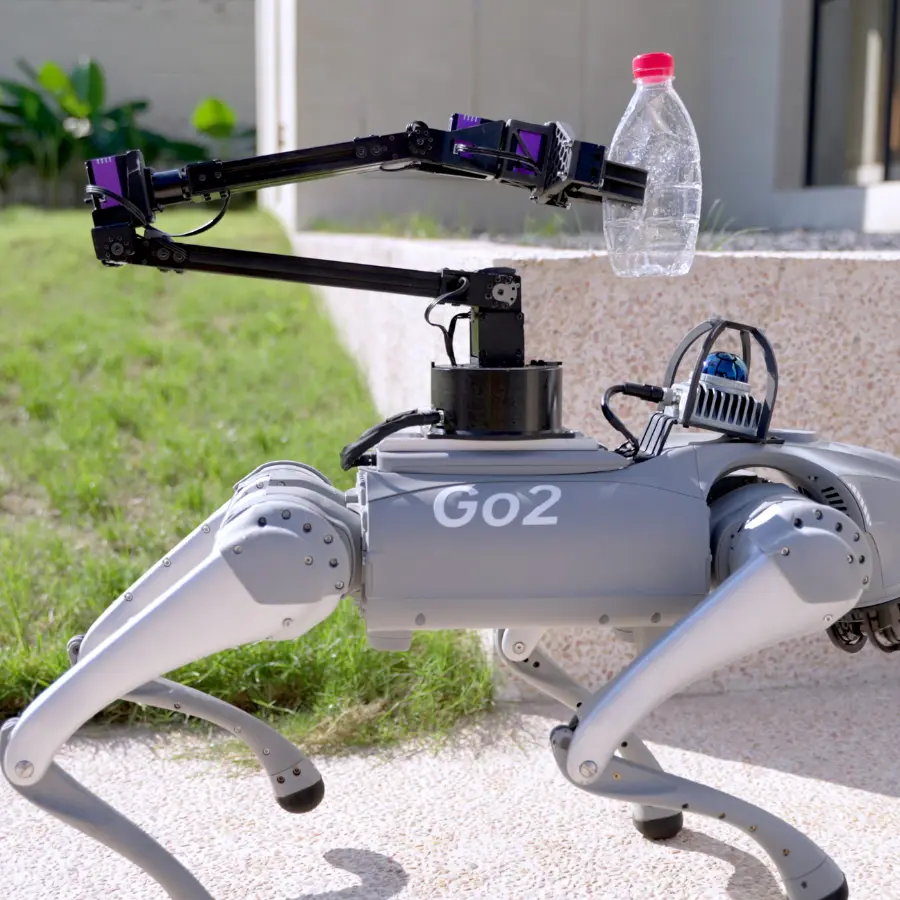 Unitree Go2 Servo Robotic Arm D1 Gripper Grasping a Bottle on Go2 The unitree go2 servo robotic arm d1 gripper holding a plastic bottle while mounted on the Go2 robot dog outdoors, end effector in action